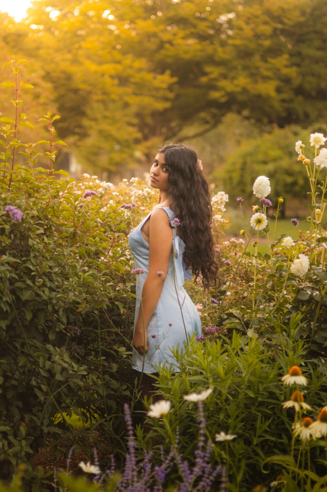 Senior portrait session among evening garden flowers