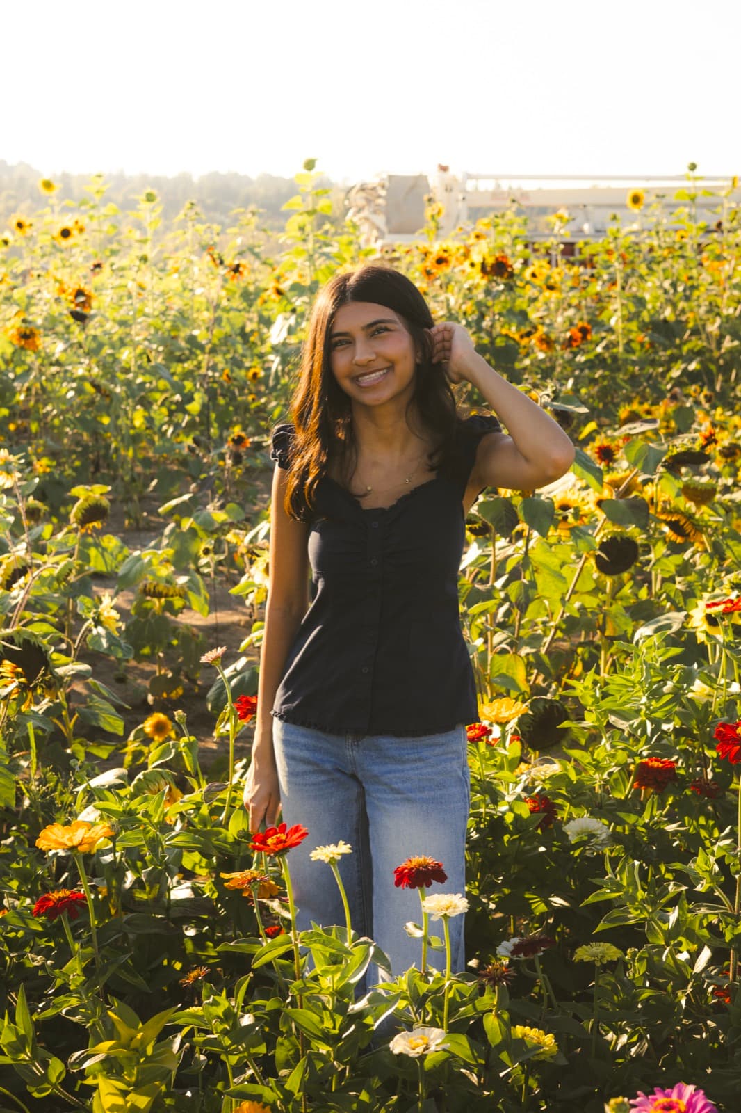 Senior portrait session at golden hour in a flower field